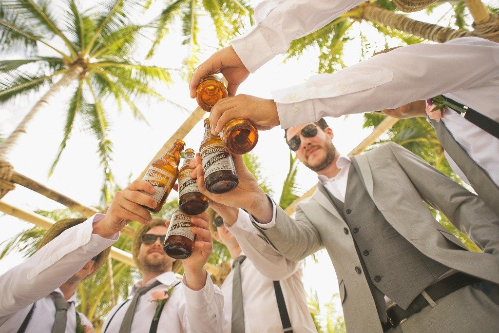 Group of friends celebrating with beer at an outdoor event