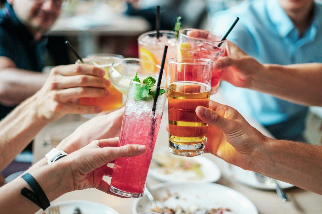 Friends toasting with colourful cocktails